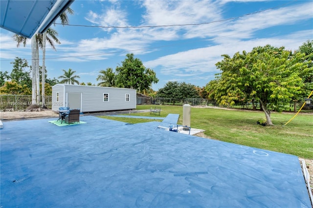 view of yard with a patio and a storage shed