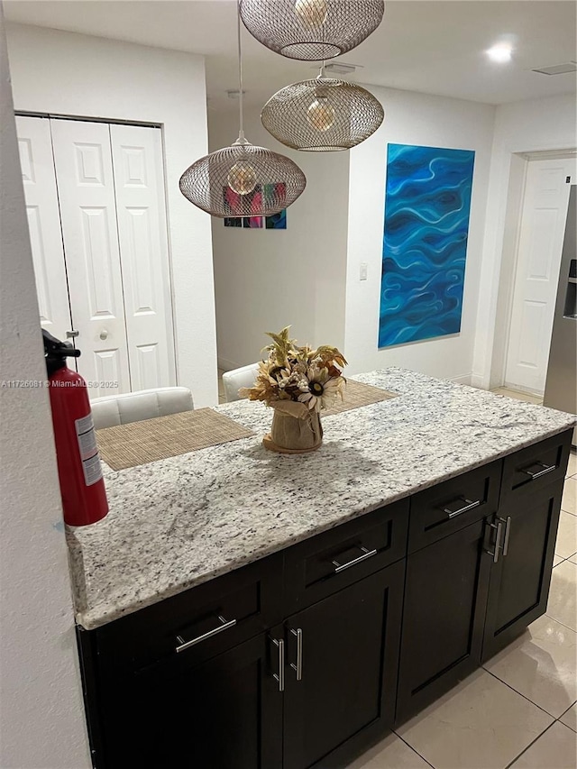 kitchen featuring light stone countertops and light tile patterned floors