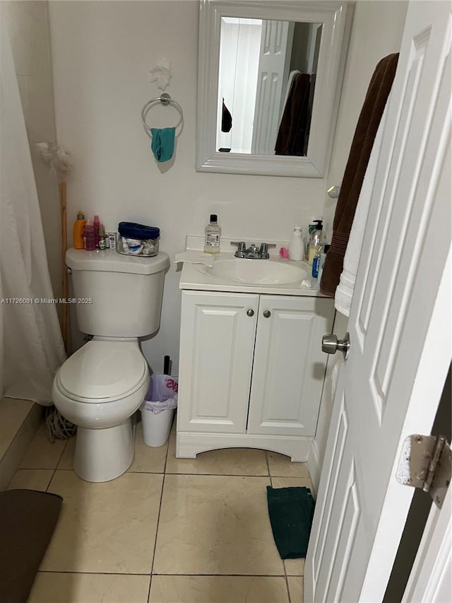 bathroom featuring tile patterned floors, toilet, and vanity