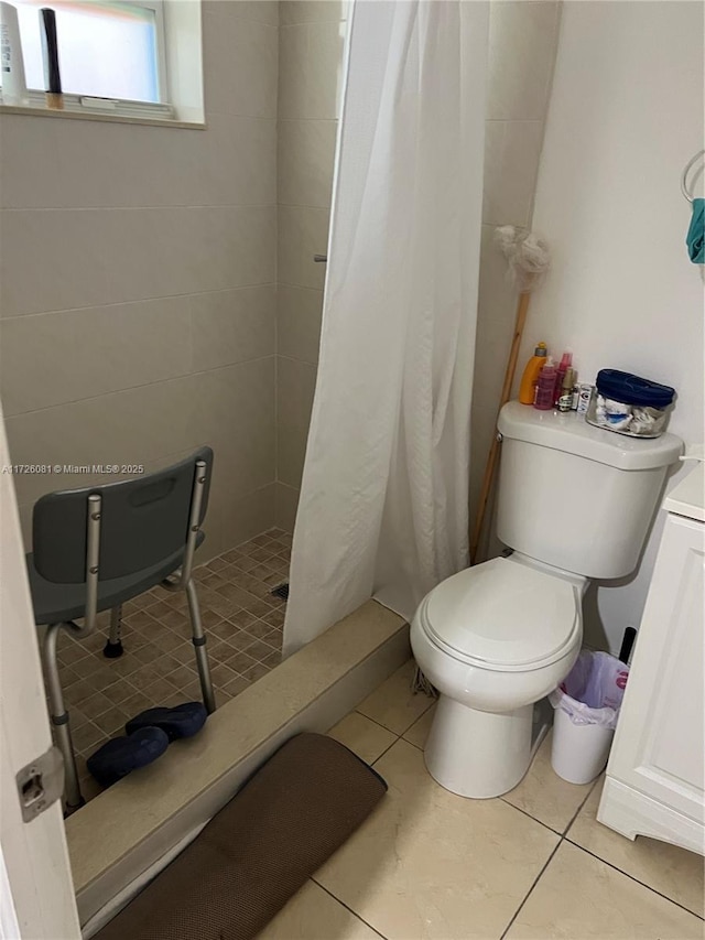 bathroom featuring tile patterned flooring, toilet, and a shower with shower curtain