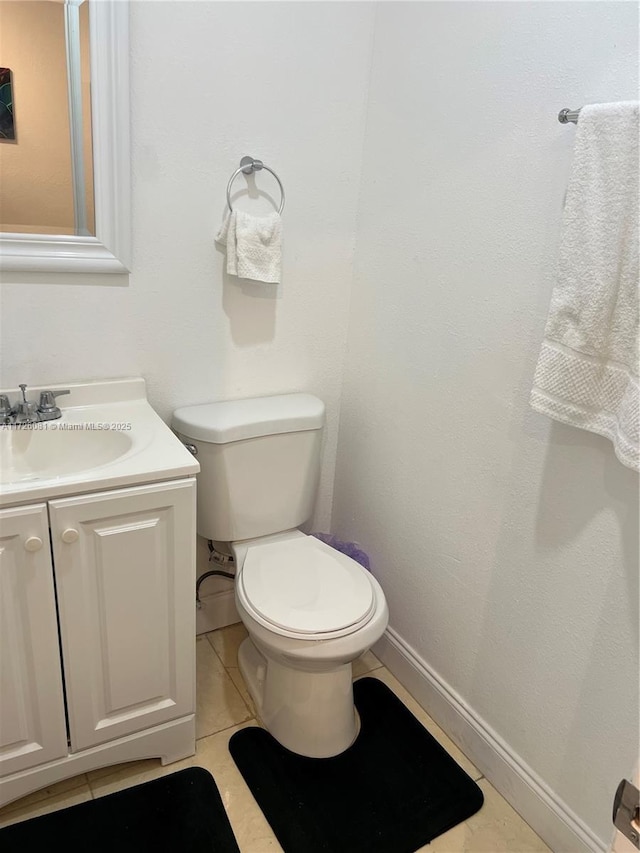 bathroom featuring vanity, toilet, and tile patterned flooring