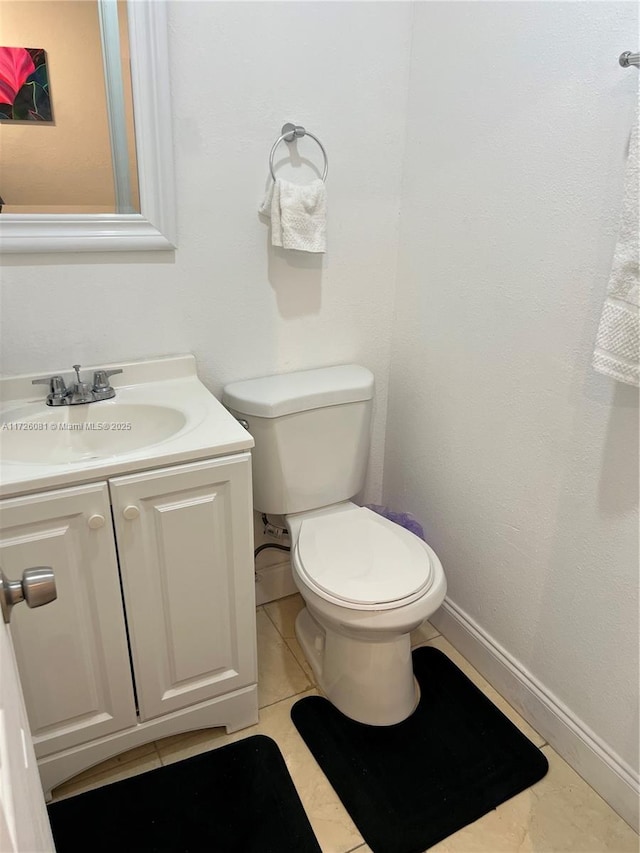 bathroom with vanity, toilet, and tile patterned flooring