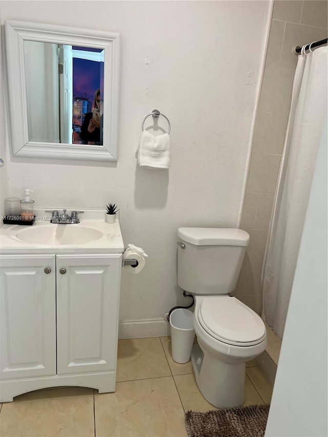 bathroom featuring vanity, curtained shower, tile patterned floors, and toilet