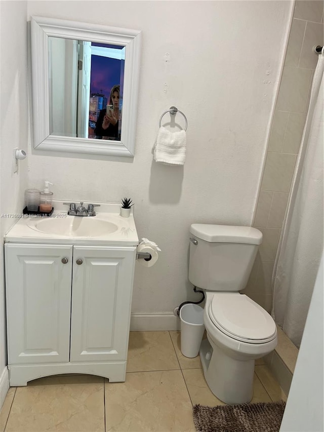 bathroom featuring tile patterned floors, toilet, a shower with shower curtain, and vanity