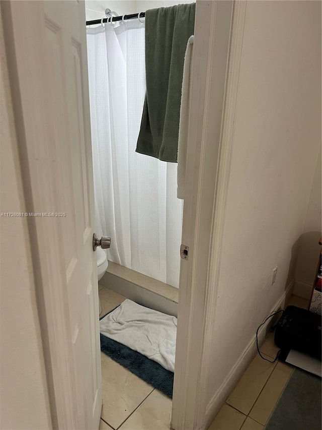 bathroom featuring tile patterned flooring and toilet