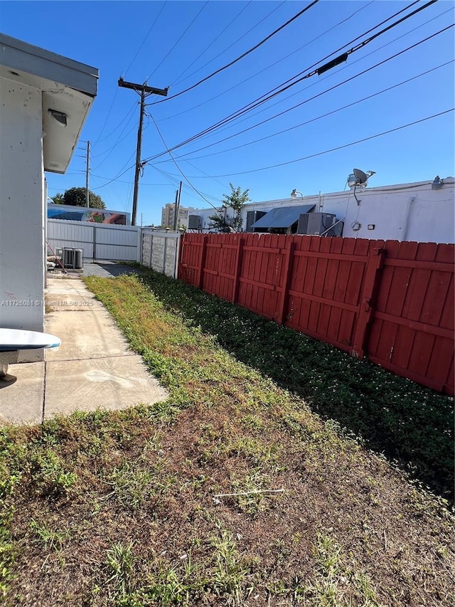 view of yard with a patio and central air condition unit