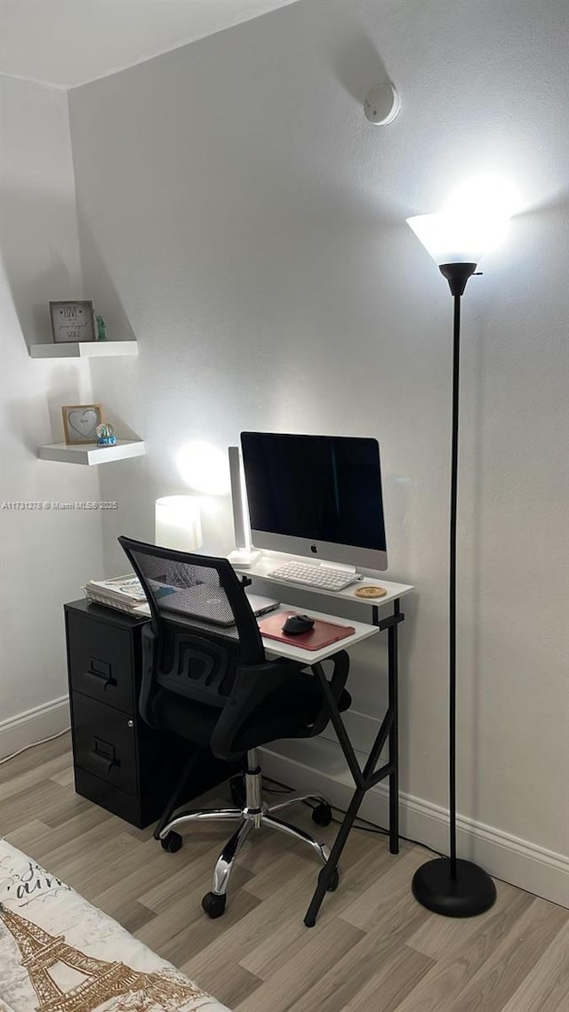 home office with light hardwood / wood-style floors