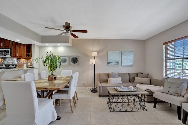 living room featuring light tile patterned floors and ceiling fan