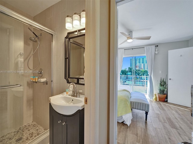 bathroom featuring vanity, ceiling fan, and a shower with shower door