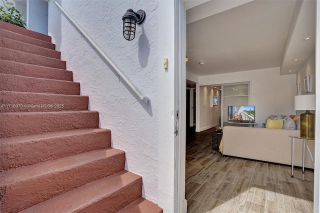 stairs with wood-type flooring