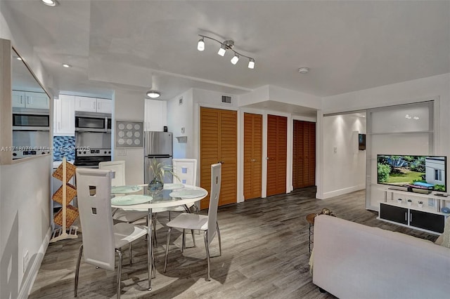 dining space with hardwood / wood-style flooring