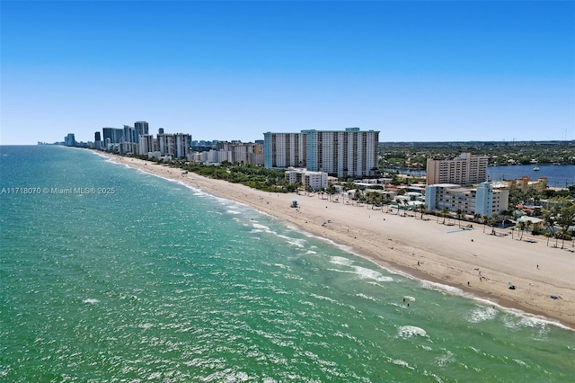 birds eye view of property with a view of the beach and a water view