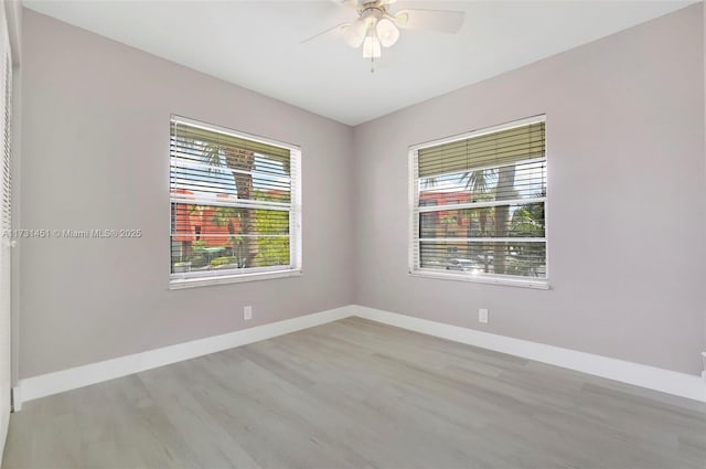 spare room featuring ceiling fan and light wood-type flooring