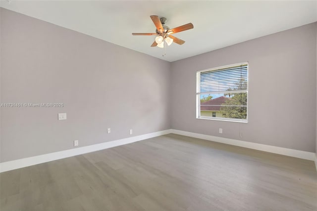 spare room with light hardwood / wood-style floors and ceiling fan