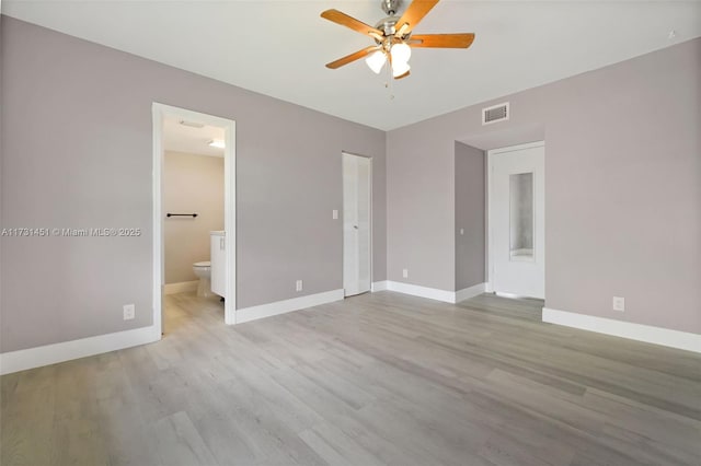 unfurnished bedroom featuring ceiling fan, ensuite bath, and light hardwood / wood-style flooring