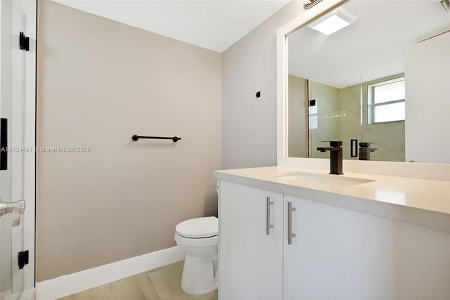 bathroom featuring vanity, hardwood / wood-style floors, walk in shower, and toilet