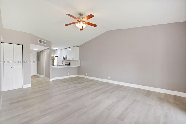 unfurnished living room featuring ceiling fan and light wood-type flooring