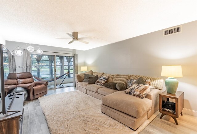 living room with hardwood / wood-style floors and ceiling fan