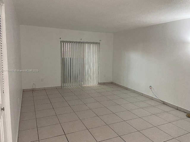 10744 N Kendall Dr Unit M11, Miami, FL 33176 - spare room with baseboards and light tile patterned flooring