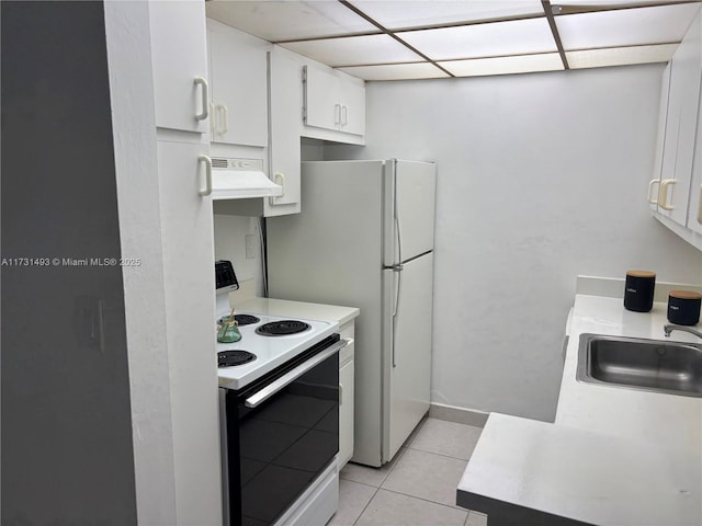 10744 N Kendall Dr Unit M11, Miami, FL 33176 - kitchen featuring light countertops, light tile patterned flooring, under cabinet range hood, range with electric stovetop, and a sink