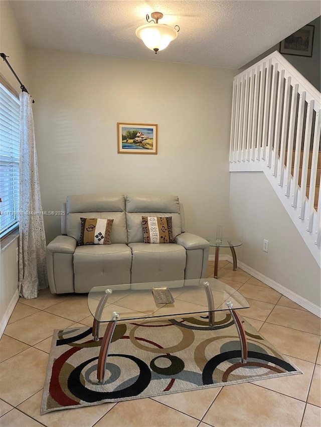 living room featuring light tile patterned floors and a textured ceiling