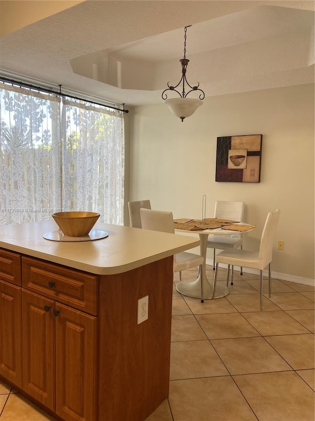 kitchen with light tile patterned floors and decorative light fixtures