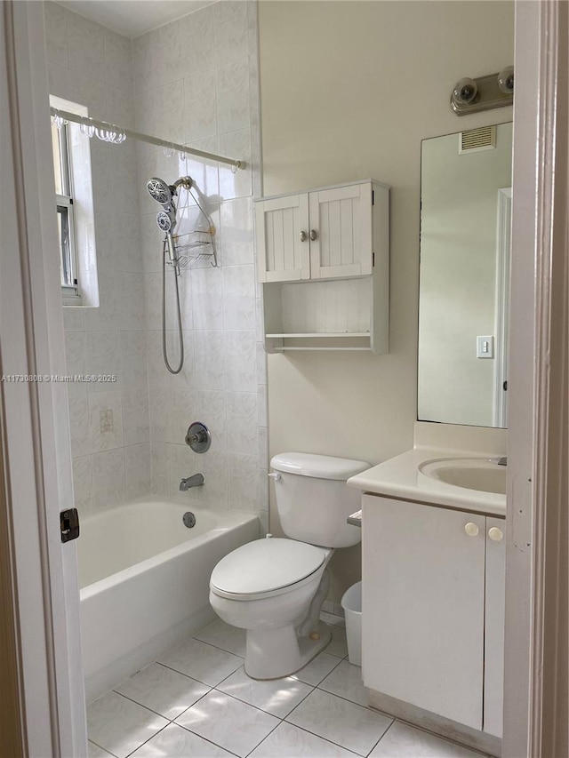 full bathroom with vanity, tiled shower / bath, tile patterned floors, and toilet