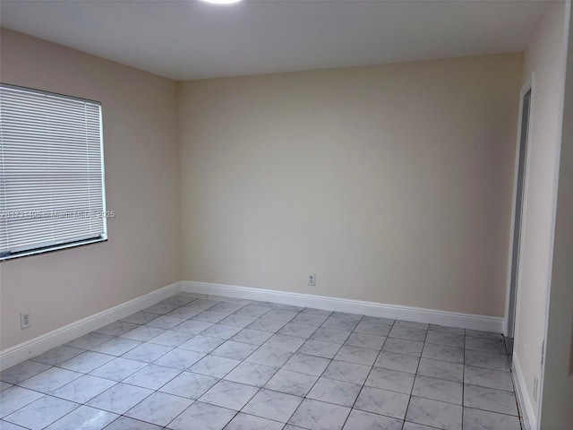 unfurnished room featuring light tile patterned flooring