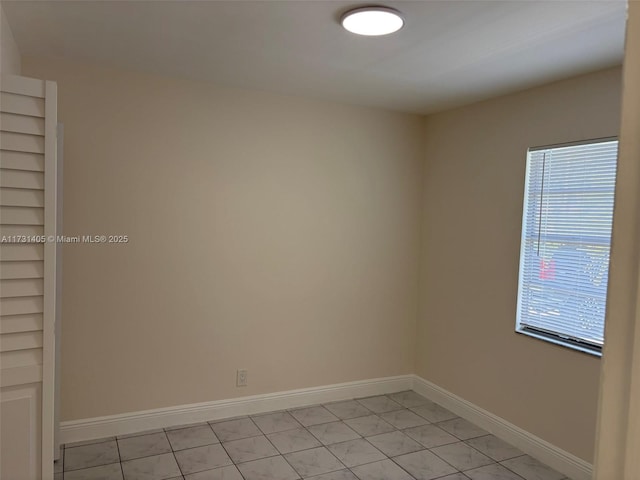 spare room featuring light tile patterned floors and plenty of natural light