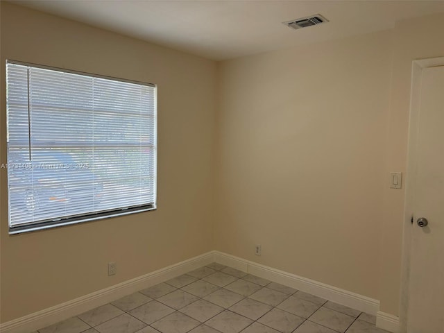 unfurnished room featuring light tile patterned floors