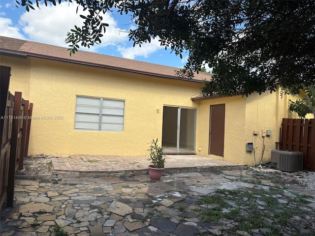 rear view of house with cooling unit and a patio area