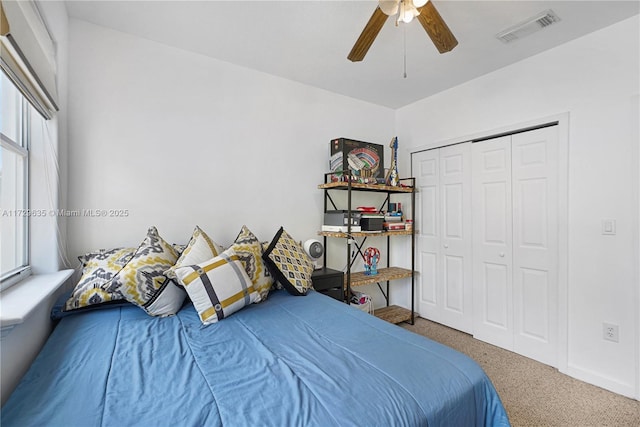 bedroom featuring a closet, ceiling fan, and carpet flooring