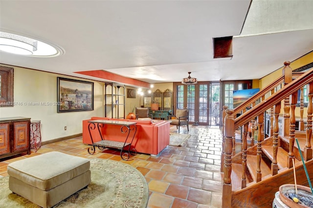 living area featuring tile patterned floors and baseboards