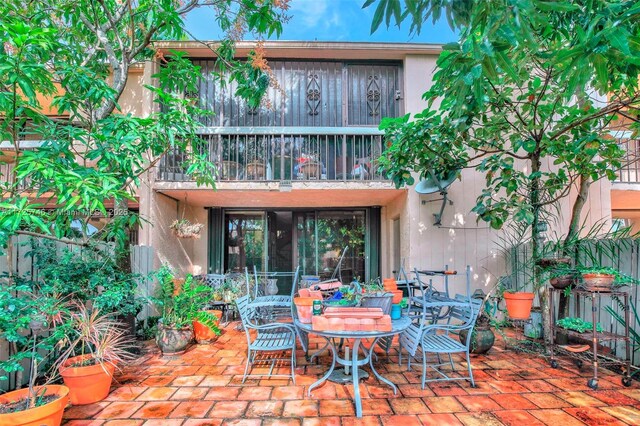 view of patio featuring a balcony