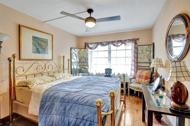 bedroom featuring wood-type flooring and ceiling fan