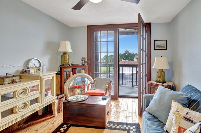 sitting room with ceiling fan and light hardwood / wood-style floors