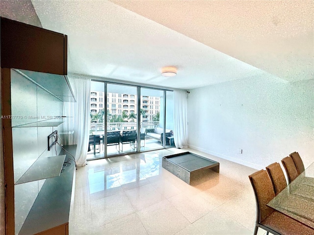 living room with expansive windows and a textured ceiling