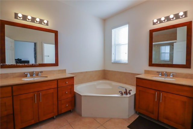 bathroom featuring vanity, a tub to relax in, and tile patterned floors