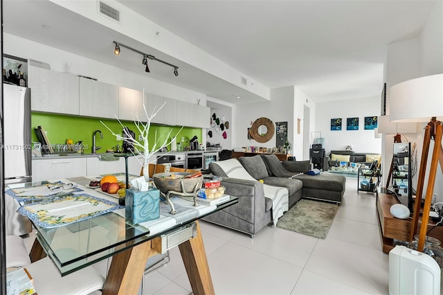 tiled living room featuring sink