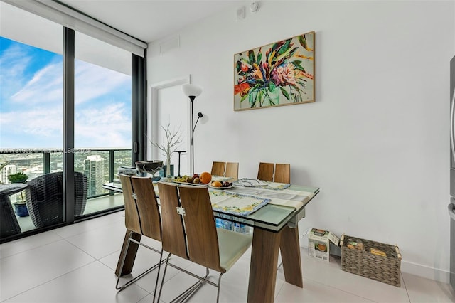 dining space featuring light tile patterned floors and expansive windows