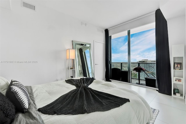 bedroom with access to outside and light tile patterned floors