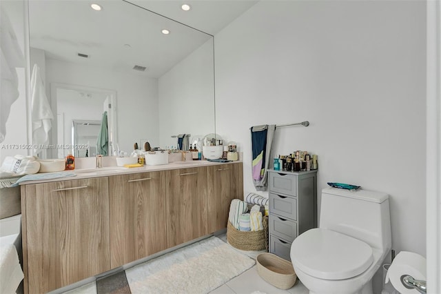 bathroom with tile patterned floors, toilet, and vanity