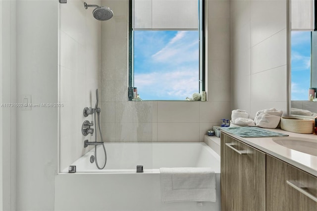 bathroom featuring vanity and tiled shower / bath combo