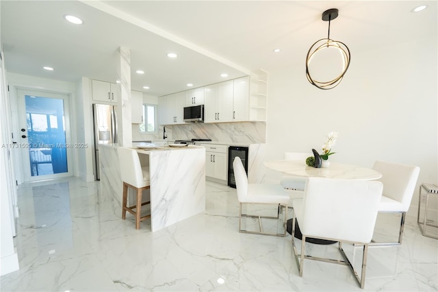 dining area featuring sink and beverage cooler