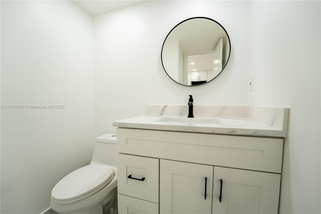 bathroom featuring vanity and toilet