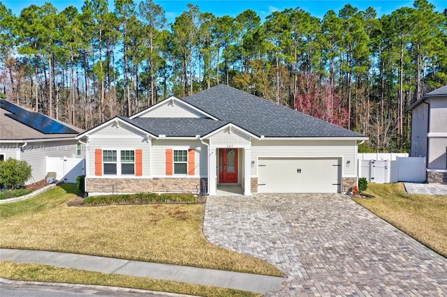 single story home featuring a garage and a front yard