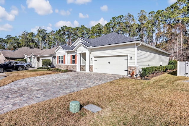 single story home featuring a garage and a front lawn