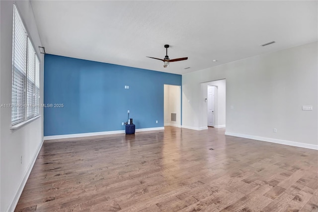 spare room with hardwood / wood-style flooring and ceiling fan