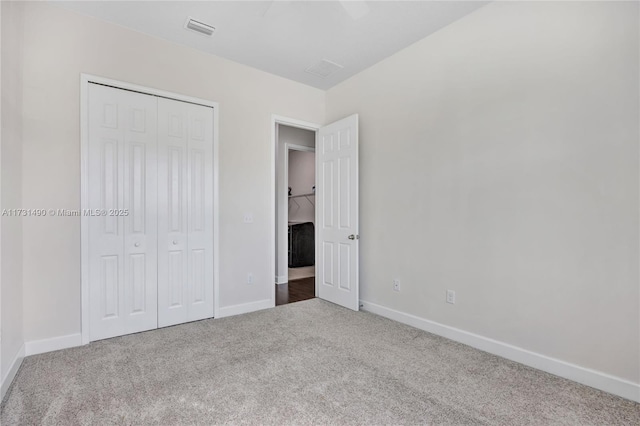 unfurnished bedroom featuring ceiling fan, carpet floors, and a closet