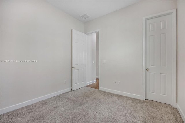 empty room with light colored carpet